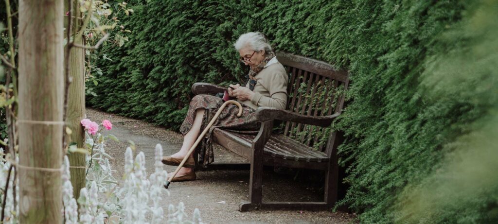 elderly lady sitting on a bench