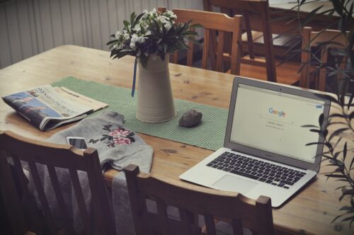 laptop on table with google displayed the screen