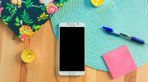 samsung phone on a table with blue table mat